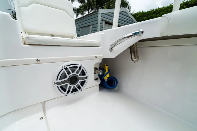  Yacht Photos Pics 2021 Everglades 243 Center Console boat interior with speaker and storage compartment.