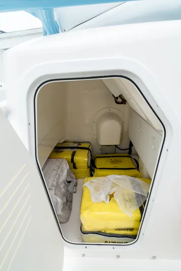  Yacht Photos Pics Storage compartment in 2021 Everglades 243 Center Console boat with yellow life jackets.