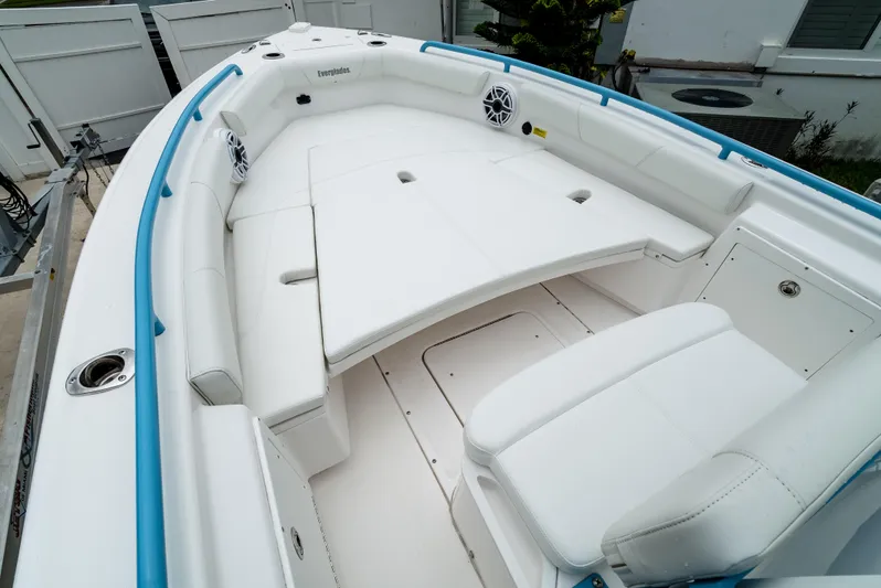  Yacht Photos Pics 2021 Everglades 243 Center Console boat with spacious white seating and blue accents.