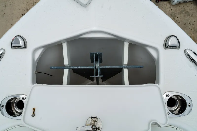  Yacht Photos Pics 2021 Everglades 243 Center Console anchor storage compartment, featuring a neatly secured anchor.