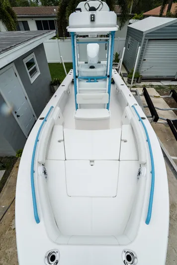  Yacht Photos Pics 2021 Everglades 243 Center Console boat with white and blue detailing, docked near houses.