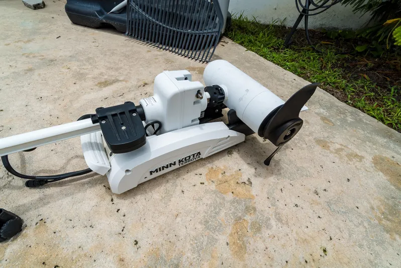  Yacht Photos Pics Minn Kota trolling motor on concrete, near Everglades 243 Center Console, 2021 model.