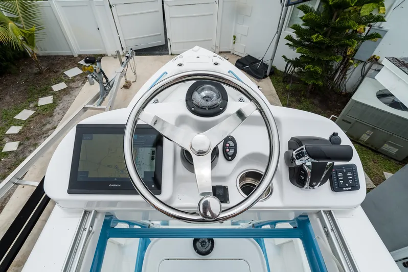  Yacht Photos Pics 2021 Everglades 243 Center Console helm with steering wheel and navigation controls.