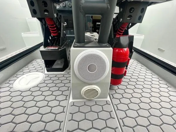  Yacht Photos Pics 2024 XO Boats DFNDR 9 interior with hexagonal flooring, speaker, and fire extinguisher.