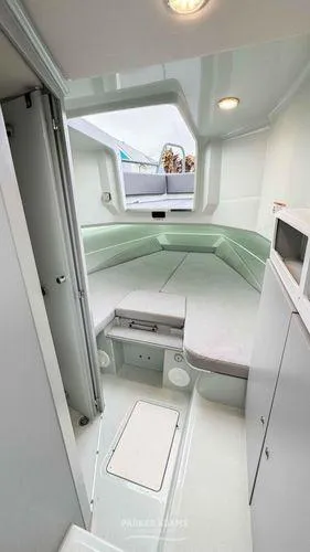  Yacht Photos Pics 2024 XO Boats DFNDR 9 cabin interior with modern design and seating area.