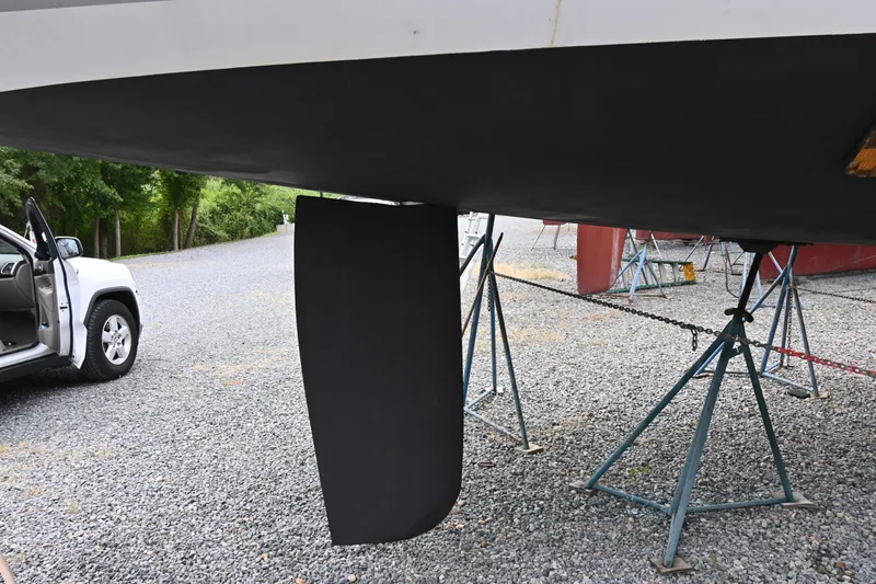 Liberty Yacht Photos Pics 2011 Beneteau Oceanis 50 sailboat keel on stands, gravel lot, open car door nearby.