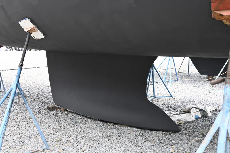 Liberty Yacht Photos Pics 2011 Beneteau Oceanis 50 sailboat keel on stands in a gravel yard.