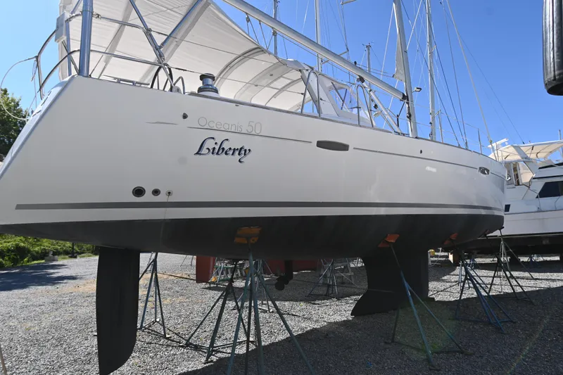 Liberty Yacht Photos Pics 2011 Beneteau Oceanis 50 sailboat on stands, named "Liberty," in a boatyard.