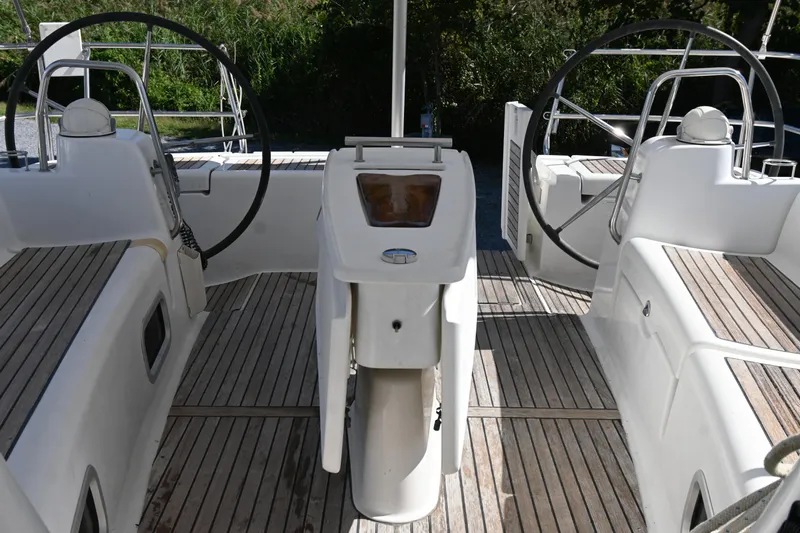 Liberty Yacht Photos Pics 2011 Beneteau Oceanis 50 yacht cockpit with dual steering wheels and wooden deck.