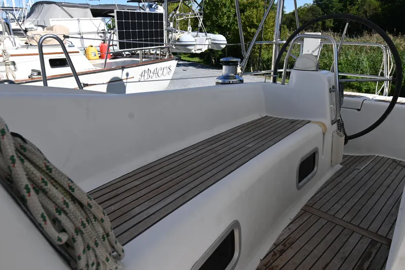 Liberty Yacht Photos Pics 2011 Beneteau Oceanis 50 sailboat cockpit with wooden seating and steering wheel.