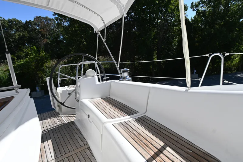 Liberty Yacht Photos Pics 2011 Beneteau Oceanis 50 yacht cockpit with wooden seating and steering wheel.