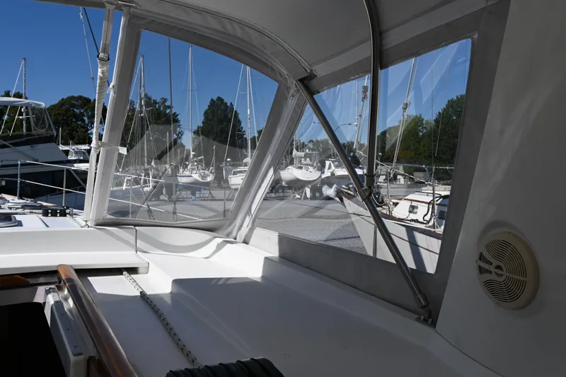 Liberty Yacht Photos Pics Cockpit view of 2011 Beneteau Oceanis 50 sailboat with marina background.