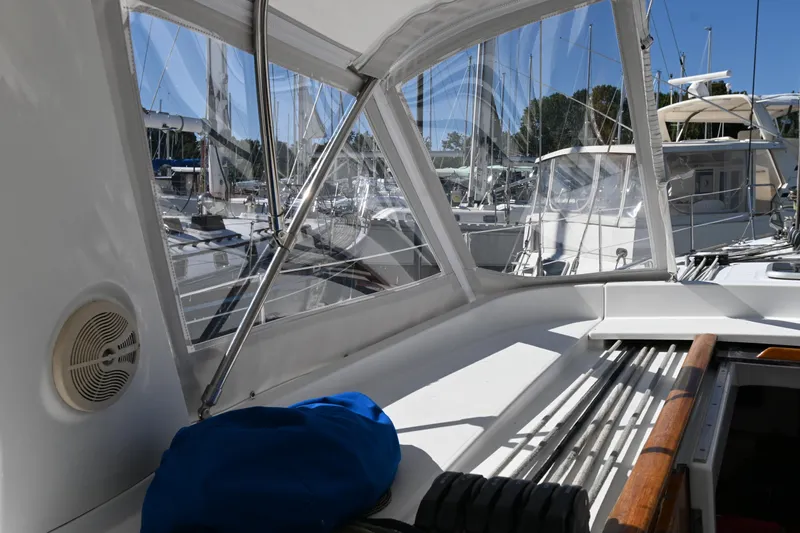 Liberty Yacht Photos Pics 2011 Beneteau Oceanis 50 sailboat cockpit with marina view, featuring clear canopy and equipment.