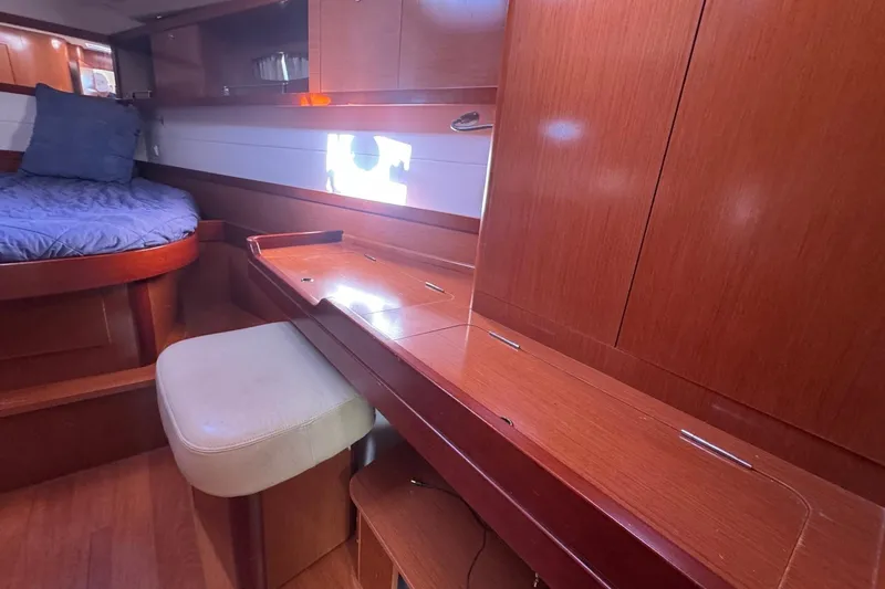 Liberty Yacht Photos Pics Interior of 2011 Beneteau Oceanis 50 yacht with wooden cabinetry and cozy seating area.