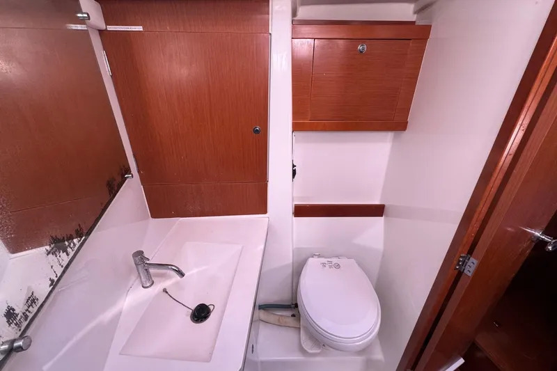 Liberty Yacht Photos Pics Bathroom interior of 2011 Beneteau Oceanis 50 yacht with sink and toilet.