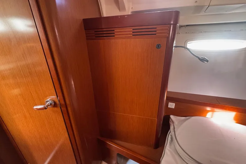 Liberty Yacht Photos Pics Interior of 2011 Beneteau Oceanis 50 yacht, featuring wooden cabinetry and cozy sleeping area.