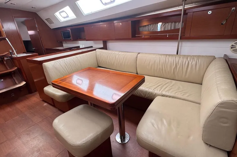 Liberty Yacht Photos Pics Luxurious interior of 2011 Beneteau Oceanis 50 yacht with leather seating and wooden table.