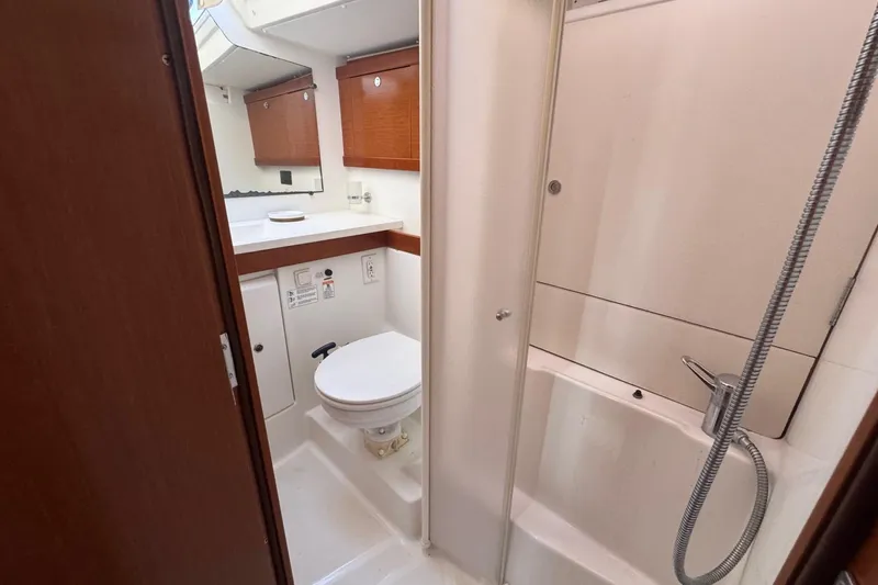 Liberty Yacht Photos Pics Bathroom interior of 2011 Beneteau Oceanis 50 yacht, featuring shower and toilet.
