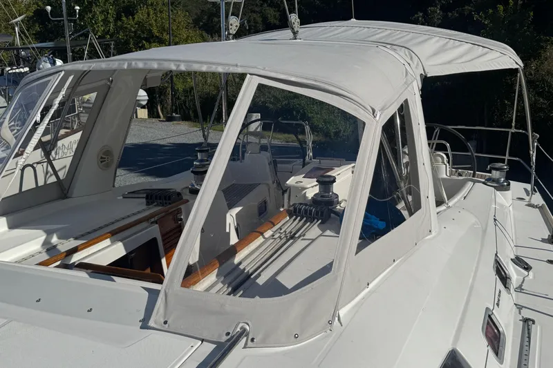 Liberty Yacht Photos Pics 2011 Beneteau Oceanis 50 sailboat with white canopy and deck, docked outdoors.