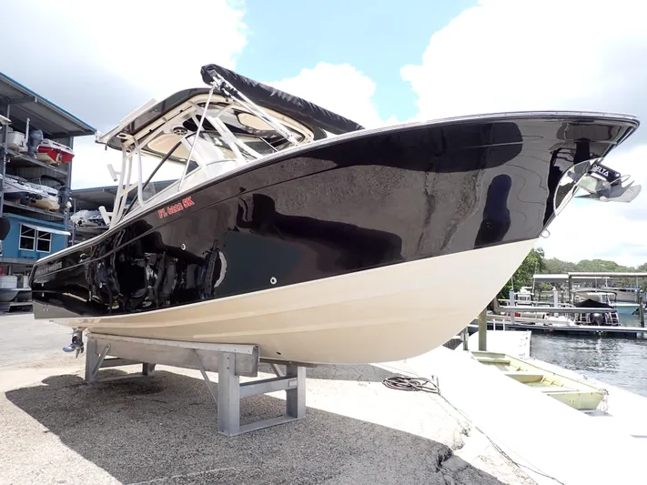  Yacht Photos Pics 2019 Grady-White Freedom 275 boat on a stand near a marina.