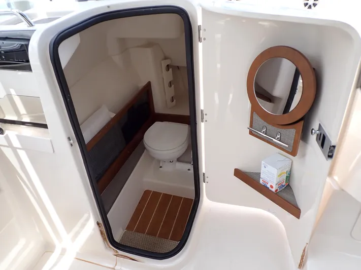  Yacht Photos Pics 2019 Grady-White Freedom 275 boat interior bathroom with toilet and mirror.