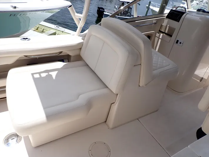  Yacht Photos Pics 2019 Grady-White Freedom 275 boat interior with white cushioned seating.