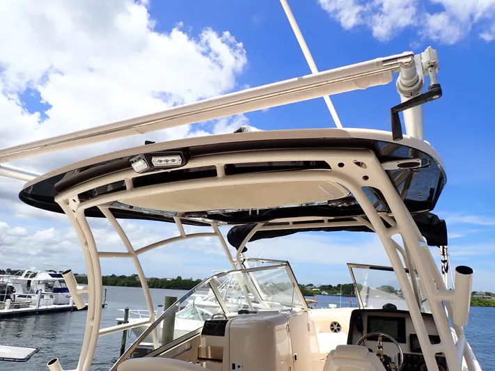  Yacht Photos Pics 2019 Grady-White Freedom 275 boat docked, showcasing helm and hardtop under blue sky.