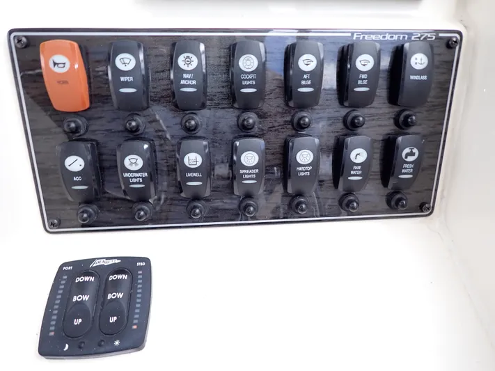  Yacht Photos Pics Control panel of a 2019 Grady-White Freedom 275 boat with various switches.