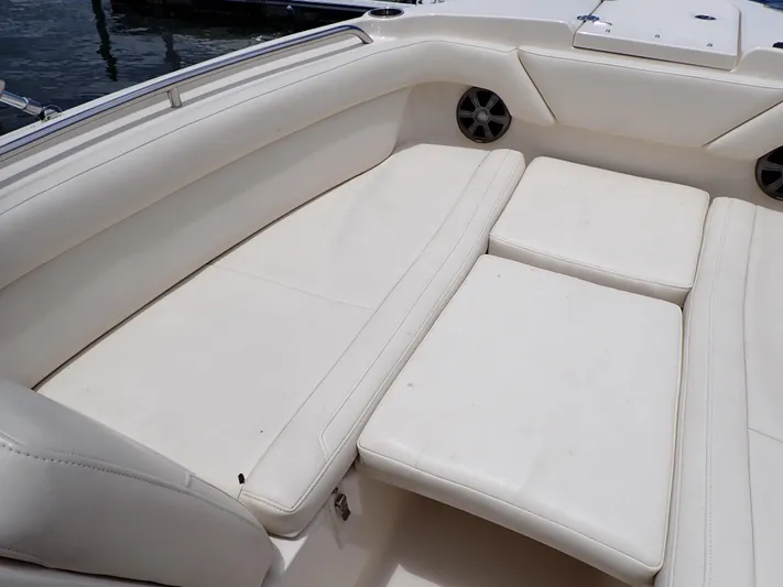  Yacht Photos Pics 2019 Grady-White Freedom 275 boat with spacious white cushioned seating.