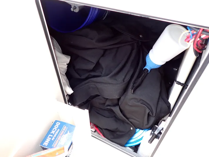  Yacht Photos Pics Storage compartment of a 2019 Grady-White Freedom 275 boat with various items.