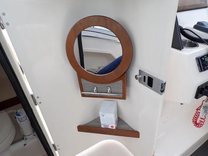  Yacht Photos Pics 2019 Grady-White Freedom 275 interior with mirror and storage shelf.