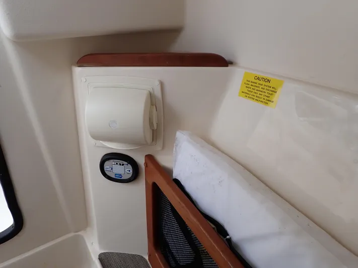  Yacht Photos Pics Interior detail of 2019 Grady-White Freedom 275 boat with caution label and storage compartment.