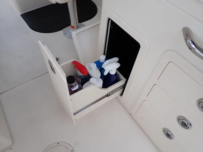  Yacht Photos Pics Storage compartment with cleaning supplies on a 2019 Grady-White Freedom 275 boat.