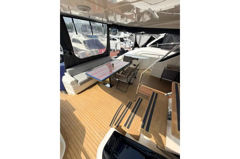  Yacht Photos Pics Luxurious 2020 Ferretti Yachts 720 deck with seating and table, showcasing elegant design.
