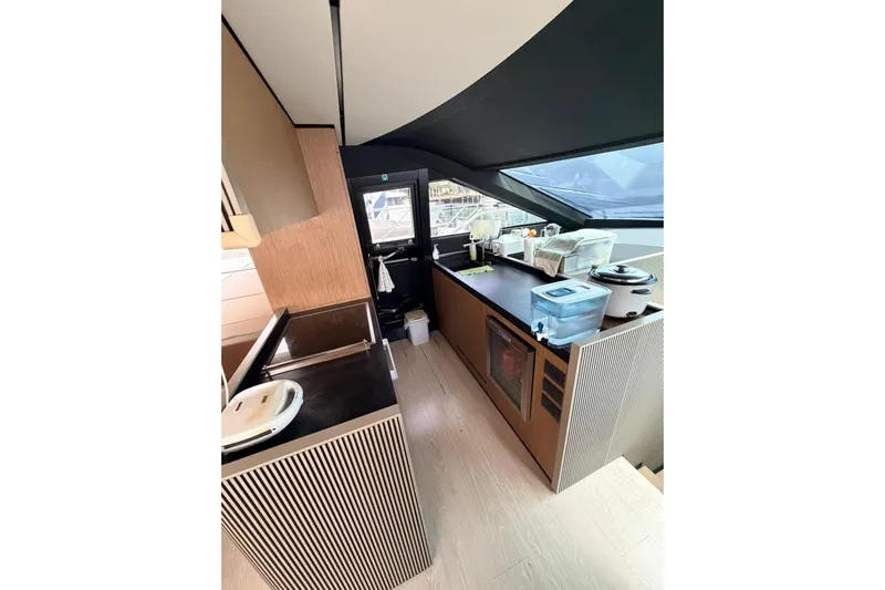  Yacht Photos Pics Modern kitchen interior of 2020 Ferretti Yachts 720, featuring sleek countertops and appliances.
