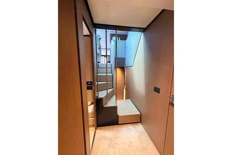  Yacht Photos Pics Interior of 2020 Ferretti Yachts 720, featuring modern staircase and sleek wooden design.