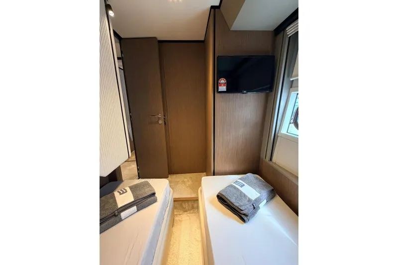  Yacht Photos Pics Interior cabin of 2020 Ferretti Yachts 720 with twin beds and wall-mounted TV.