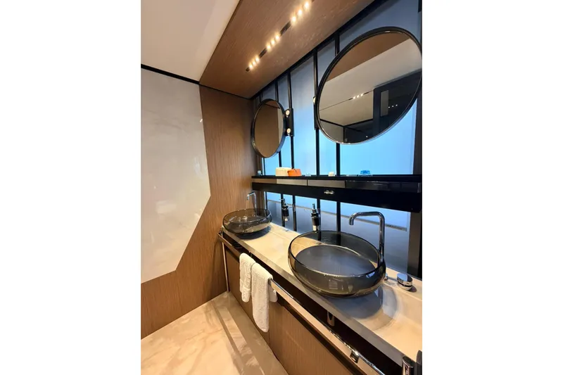  Yacht Photos Pics Luxurious bathroom in 2020 Ferretti Yachts 720, featuring modern sinks and elegant mirrors.