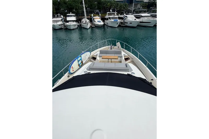  Yacht Photos Pics Ferretti Yachts 720, 2020 model, docked with surfboards on deck, surrounded by other boats.