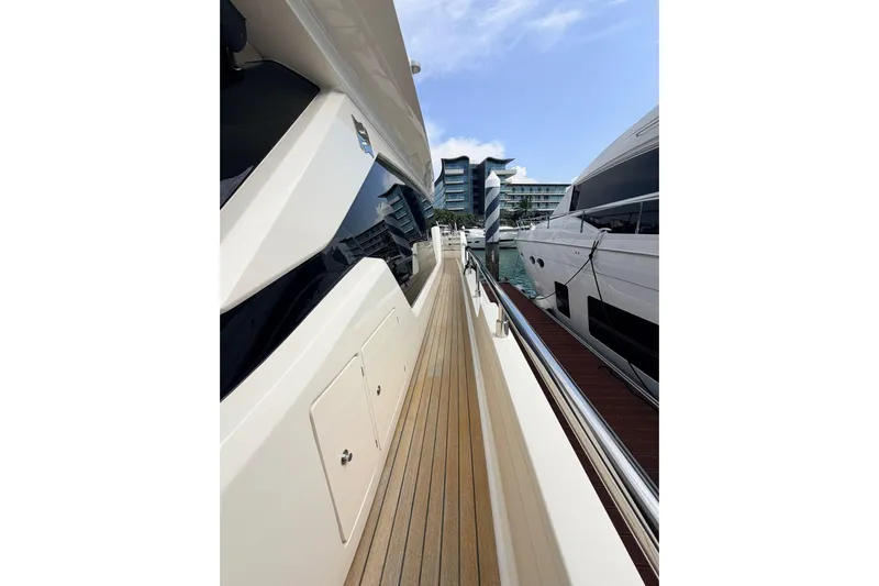  Yacht Photos Pics Side view of 2020 Ferretti Yachts 720 docked, showcasing sleek design and wooden deck.