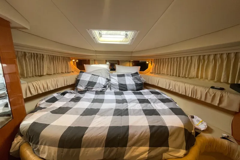 Priorities Yacht Photos Pics Luxurious cabin interior of 1999 Sea Ray 380 Sundancer with cozy bed and elegant lighting.