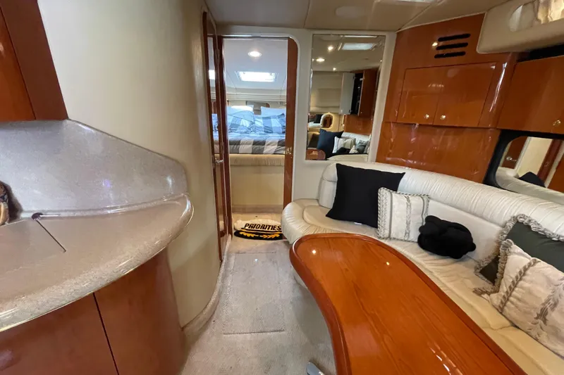 Priorities Yacht Photos Pics Interior of 1999 Sea Ray 380 Sundancer yacht with plush seating and elegant wood finishes.