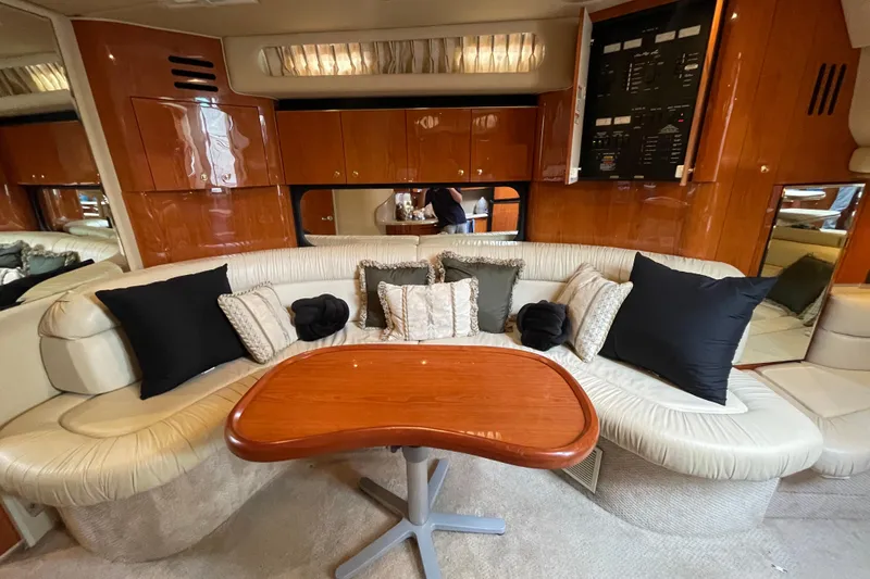 Priorities Yacht Photos Pics Luxurious interior of 1999 Sea Ray 380 Sundancer with plush seating and elegant wood finishes.