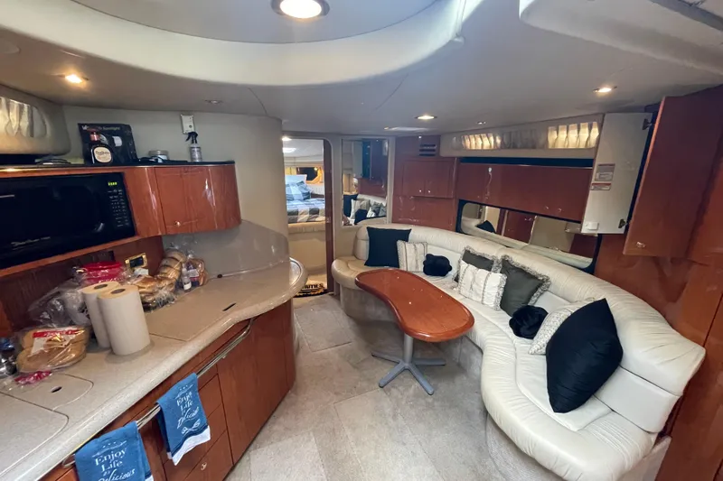 Priorities Yacht Photos Pics Luxurious interior of 1999 Sea Ray 380 Sundancer yacht with kitchen and seating area.