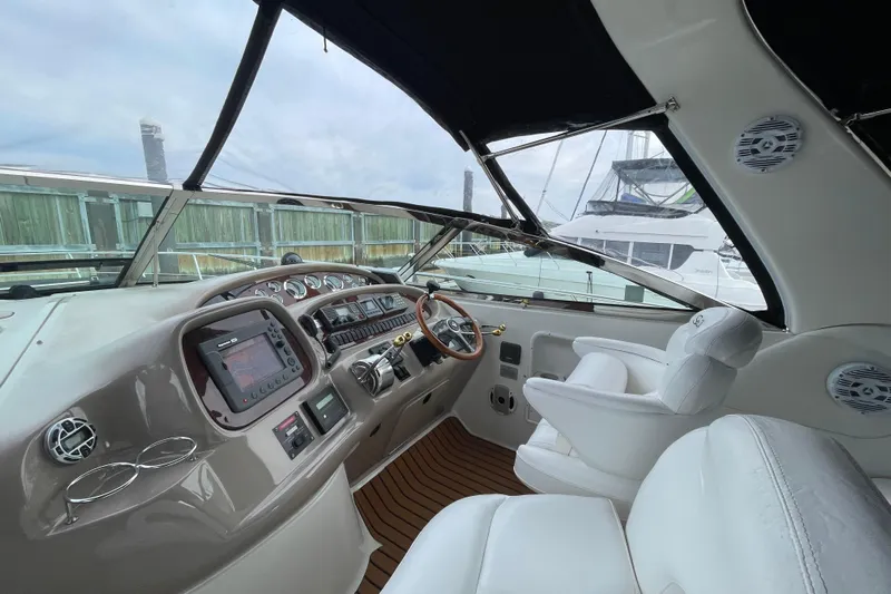 Priorities Yacht Photos Pics 1999 Sea Ray 380 Sundancer helm with modern controls and luxurious seating.
