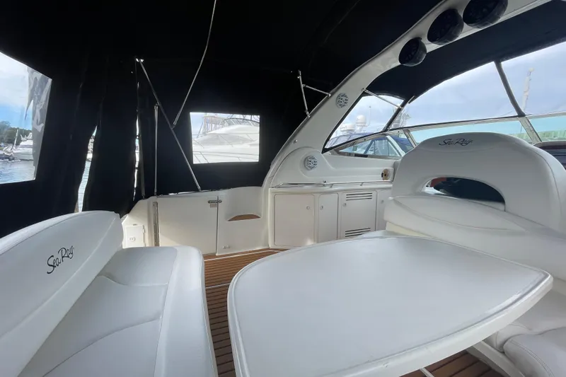 Priorities Yacht Photos Pics Interior of 1999 Sea Ray 380 Sundancer yacht with white seating and wood flooring.