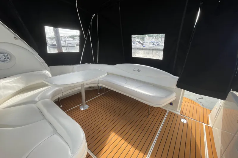 Priorities Yacht Photos Pics 1999 Sea Ray 380 Sundancer interior with white seating and wooden flooring.