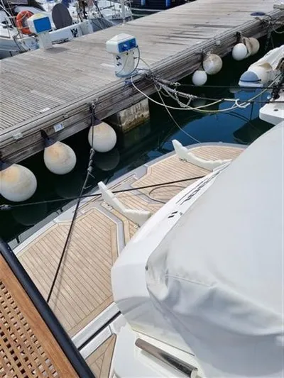  Yacht Photos Pics 2019 Cranchi 60HT yacht docked with wooden deck and mooring buoys.