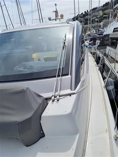  Yacht Photos Pics 2019 Cranchi 60HT yacht docked at marina, side view with sleek design.
