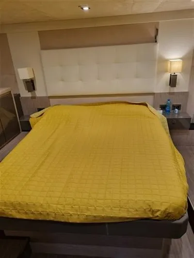  Yacht Photos Pics Luxurious bedroom interior of 2019 Cranchi 60HT yacht with yellow bedding.